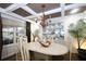 Elegant dining room features a coffered ceiling, chandelier, and a built-in display cabinet for storage at 402 Rising Cir, Woodstock, GA 30189