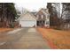 Inviting two-story home features a brick and vinyl exterior, two-car garage, and a well-manicured front lawn at 402 Rising Cir, Woodstock, GA 30189