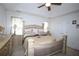 A primary bedroom features vaulted ceiling, a large bed, soft lighting and neutral colored walls at 402 Rising Cir, Woodstock, GA 30189