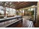 Charming outdoor dining area with pergola-covered seating and well-manicured garden at 402 Rising Cir, Woodstock, GA 30189