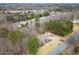 Aerial view of home showcasing its placement within a lush, established neighborhood at 5020 Puritan Dr, Sugar Hill, GA 30518