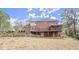 Backyard view of a charming brick two-story home with a deck and screened porch at 5020 Puritan Dr, Sugar Hill, GA 30518