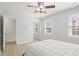 Bedroom featuring two large windows, a ceiling fan, and a queen-sized bed at 5020 Puritan Dr, Sugar Hill, GA 30518