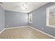 Bedroom featuring light blue walls, white trim, and two windows with natural light at 5020 Puritan Dr, Sugar Hill, GA 30518