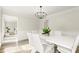 Dining room showcasing clean lines, neutral paint, modern light fixture and view to living area at 5020 Puritan Dr, Sugar Hill, GA 30518