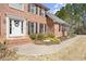 Brick home featuring a white front door with lovely landscaping and a stone walkway at 5020 Puritan Dr, Sugar Hill, GA 30518