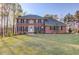 Traditional brick home with manicured lawn and symmetrical facade exudes curb appeal at 5020 Puritan Dr, Sugar Hill, GA 30518