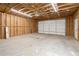 Spacious detached garage features high ceilings and ample storage capacity for vehicles and equipment at 5020 Puritan Dr, Sugar Hill, GA 30518