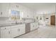 Bright kitchen with stainless steel appliances, granite countertops, and white cabinetry at 5020 Puritan Dr, Sugar Hill, GA 30518