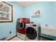 Well-equipped laundry room with modern washer and dryer and sink at 5020 Puritan Dr, Sugar Hill, GA 30518