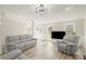 Bright and airy living room showcasing hardwood floors, a modern light fixture, and comfortable seating at 5020 Puritan Dr, Sugar Hill, GA 30518