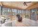 Relaxing sunroom with wooded views, ceiling fan and comfortable seating including a recliner at 5020 Puritan Dr, Sugar Hill, GA 30518