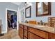 Main bathroom featuring double sinks, granite counters, and a walk-in closet at 9204 Malcolm Dr, Covington, GA 30014