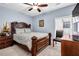 Cozy bedroom with a wooden bed frame, carpet, and a window at 9204 Malcolm Dr, Covington, GA 30014