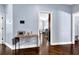 Hallway with hardwood floors and a view into the kitchen and dining area at 9204 Malcolm Dr, Covington, GA 30014