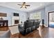 Relaxing living room showcasing a fireplace, natural light and a comfortable reclining sofa at 9204 Malcolm Dr, Covington, GA 30014