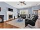 Comfortable living area boasting a fireplace, large windows, and stylish hardwood flooring at 9204 Malcolm Dr, Covington, GA 30014