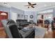 Spacious living room with hardwood flooring, adjacent to the kitchen and dining area, with access to other rooms at 9204 Malcolm Dr, Covington, GA 30014