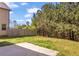 Backyard featuring green grass, fence, a small patio, and trees at 11961 Lovejoy Crossing Way, Hampton, GA 30228