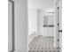 Bright bathroom with black and white tile floors, vanity, large mirror, and shower with glass door at 11961 Lovejoy Crossing Way, Hampton, GA 30228