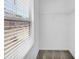 Walk-in closet with carpet floors, overhead shelving, and a bright window overlooking the street at 11961 Lovejoy Crossing Way, Hampton, GA 30228