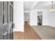 Bright entryway featuring sleek hardwood floors, leading into the open-concept living area and kitchen at 11961 Lovejoy Crossing Way, Hampton, GA 30228