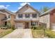 Charming two-story home with a brick facade, gray siding and a well-manicured front lawn at 11961 Lovejoy Crossing Way, Hampton, GA 30228