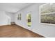 Bright living room with wood flooring, stairs, and large windows at 11961 Lovejoy Crossing Way, Hampton, GA 30228