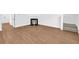 Spacious living area with sleek wood floors, a cozy fireplace, and easy access to the staircase at 11961 Lovejoy Crossing Way, Hampton, GA 30228