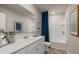 Well-lit bathroom with white vanity, framed mirror, and shower with modern fixtures at 1217 Arnhem Dr, Hampton, GA 30228