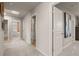 Bright hallway featuring neutral walls and carpet and several white doors at 1217 Arnhem Dr, Hampton, GA 30228