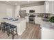 Modern kitchen featuring stainless steel appliances, a breakfast bar, and white cabinetry at 1217 Arnhem Dr, Hampton, GA 30228