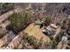 Aerial view of property featuring mature trees, lawn, outbuildings, and swimming pool at 1537 David Lee St, Acworth, GA 30102
