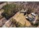 Aerial view of property with multiple structures and expansive yard, bordered by dense woodlands at 1537 David Lee St, Acworth, GA 30102