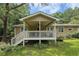 Inviting covered back porch with stairs and ceiling fan, perfect for outdoor relaxation at 1537 David Lee St, Acworth, GA 30102