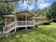 Inviting covered back porch with stairs and ceiling fan overlooking lush green yard at 1537 David Lee St, Acworth, GA 30102