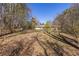 Backyard view, house in the distance, surrounded by mature trees and lush landscaping at 1537 David Lee St, Acworth, GA 30102