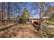 Backyard view showing the fence, trees, outbuilding and house in the distance at 1537 David Lee St, Acworth, GA 30102