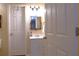 This bathroom features a white vanity and a decorative mirror, blending functionality with a clean aesthetic at 1537 David Lee St, Acworth, GA 30102