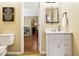 Half bath with a sleek vanity, decorative mirror, modern fixtures, and neutral color palette at 1537 David Lee St, Acworth, GA 30102