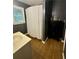 Dark painted bathroom with a white sink, white shower curtain, wood floors, and a cabinet at 1537 David Lee St, Acworth, GA 30102