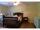 This bedroom features a wooden crib, a side table and a vintage dresser for ample storage and style at 1537 David Lee St, Acworth, GA 30102