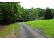 Long paved driveway leading up to a charming house, surrounded by lush trees and greenery at 1537 David Lee St, Acworth, GA 30102