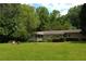 Charming ranch-style home featuring a spacious front yard and inviting covered porch with outdoor seating at 1537 David Lee St, Acworth, GA 30102