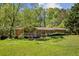 Cozy single-story home with a well-maintained lawn and mature trees at 1537 David Lee St, Acworth, GA 30102