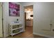 Hallway with art and partial view of open kitchen at 1537 David Lee St, Acworth, GA 30102