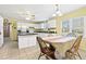 Sunlit kitchen featuring white cabinets, island, and dining area with large windows at 1537 David Lee St, Acworth, GA 30102
