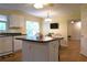Open kitchen boasting an island with dark countertops and seamless flow to a connected living area at 1537 David Lee St, Acworth, GA 30102