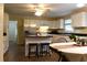 Well-lit kitchen featuring white cabinets, stainless steel appliances, and a center island with breakfast bar at 1537 David Lee St, Acworth, GA 30102