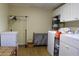 The laundry room is equipped with modern washer and dryer units, ample storage, and a freezer for added convenience at 1537 David Lee St, Acworth, GA 30102